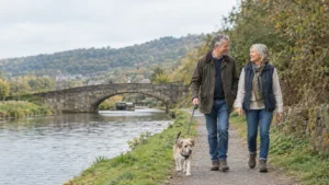 Active couple in their sixties walking together along the Calder Valley towpath in Yorkshire